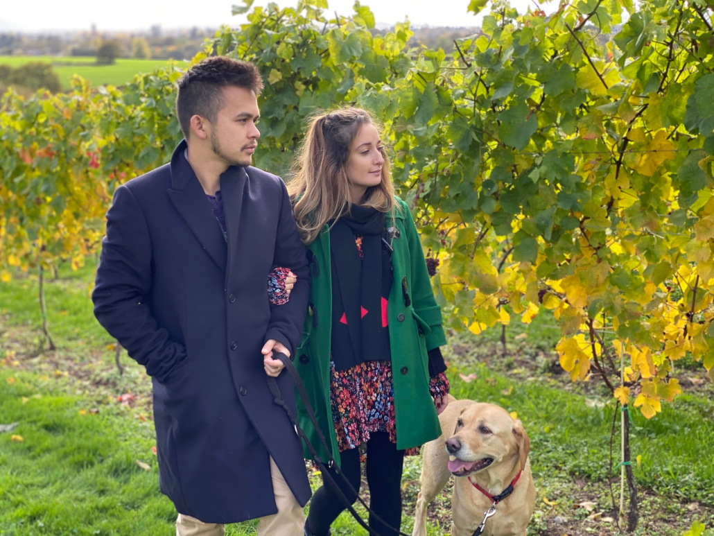 Couple walking vineyard with Dog